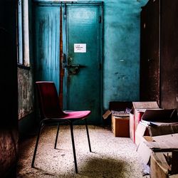 Empty chairs and table in abandoned building
