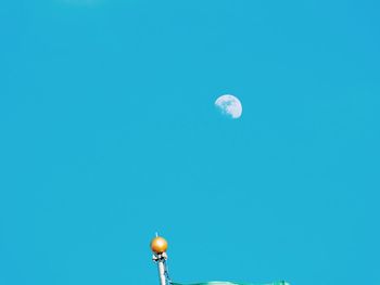 Low angle view of lamp post against clear blue sky
