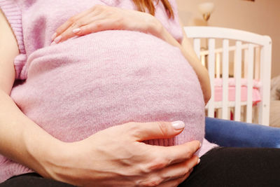 Midsection of doctor examining patient at home