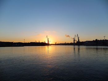 Scenic view of river against sky at sunset