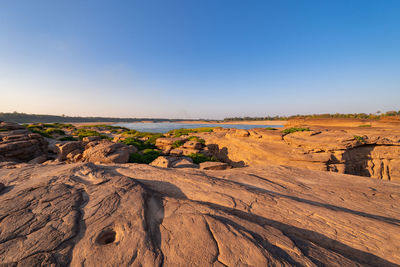 Scenic view of desert against clear blue sky