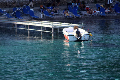 People sitting on boat in sea