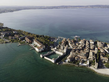 High angle view of buildings by sea