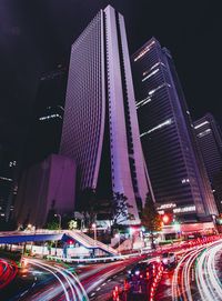 Aerial view of illuminated city street and buildings at night