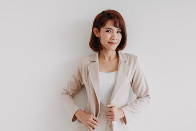 Portrait of beautiful young woman over white background