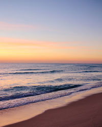 Scenic view of an ocean against sky during sunrise