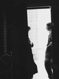 Woman standing against wall