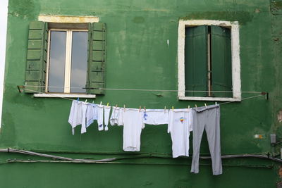 Clothes drying against white wall of building