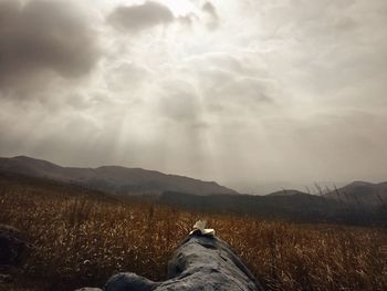 Scenic view of mountains against cloudy sky