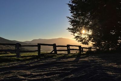 Scenic view of landscape against clear sky during sunset