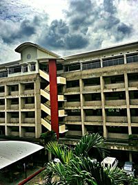 Low angle view of building against cloudy sky