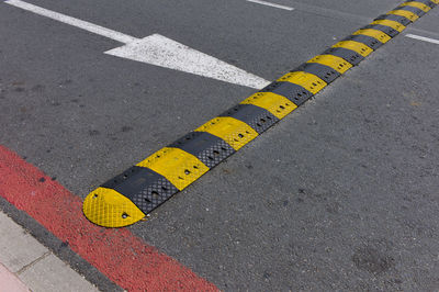 High angle view of yellow road sign on street