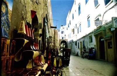 Cars on street amidst buildings in town