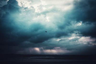 Scenic view of sea against storm clouds in sky