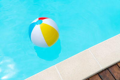 High angle view of ball floating on swimming pool