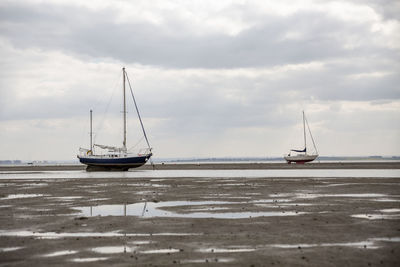 Fisherman boats stuck on the beach in low tide period in leigh-on-sea, uk.