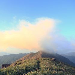 Scenic view of mountains against cloudy sky