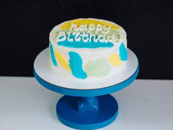 Close-up of cake on table against black background