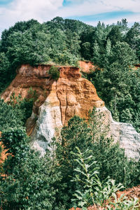 Rock formation and trees against sky