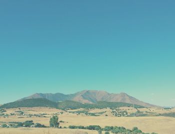 Scenic view of mountains against clear blue sky