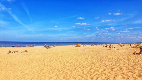 Group of people on beach against sky