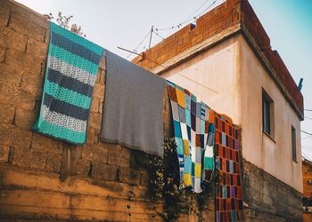 Low angle view of flags hanging against buildings