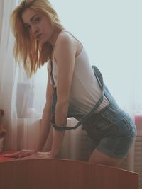 Young woman standing at home