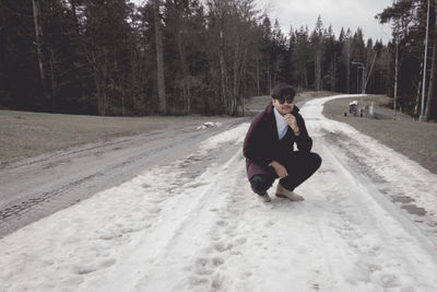 Woman on road in forest during winter