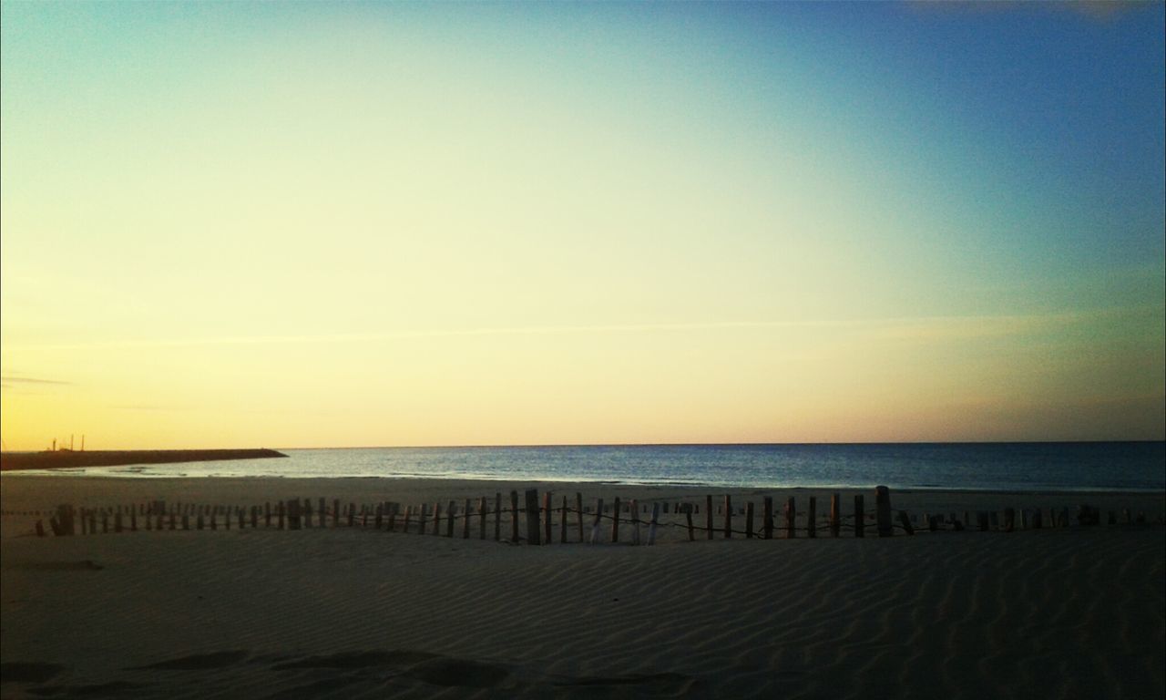 sea, horizon over water, beach, water, tranquil scene, tranquility, scenics, sand, beauty in nature, shore, copy space, nature, sunset, clear sky, idyllic, sky, calm, remote, outdoors, coastline