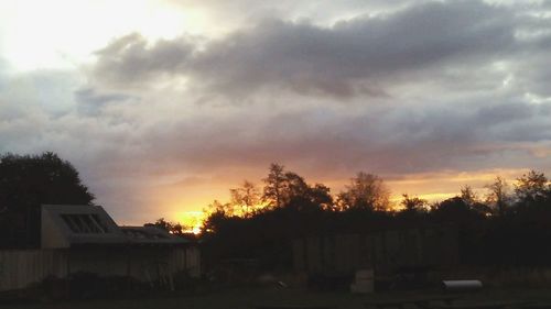 Houses against sky during sunset