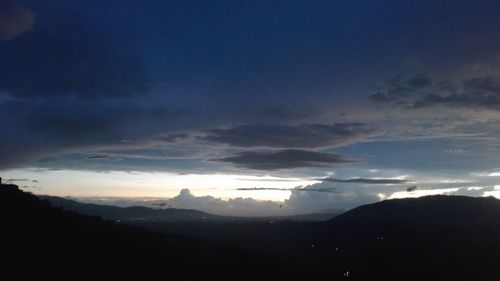 Scenic view of silhouette mountains against sky during sunset