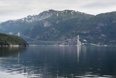 Scenic view of bridge over mountains against sky