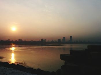 Scenic view of river at sunset