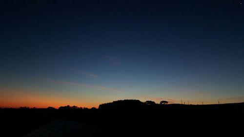 Silhouette landscape against sky during sunset