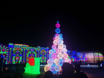 Illuminated lights against clear sky at night