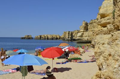 View of rocky beach against blue sky