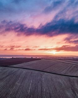 Scenic view of field against sky during sunset