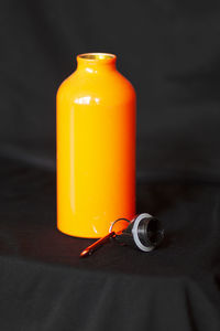 Close-up of yellow bottle on table