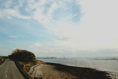 Road by sea against sky