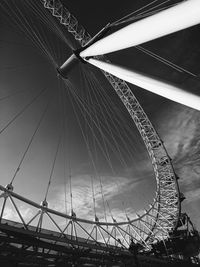 Low angle view of ferris wheel against sky in city