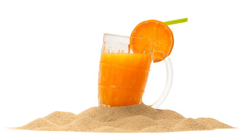 Close-up of orange juice against white background