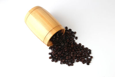 High angle view of coffee beans against white background