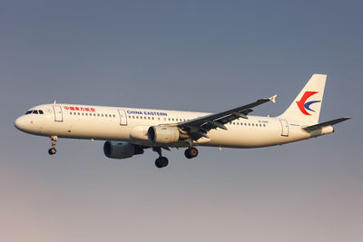 Low angle view of airplane flying against clear sky