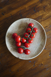 High angle view of cherries in plate on table