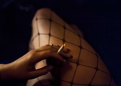 Midsection of woman holding cigarette