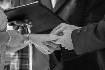 Midsection of couple holding hands