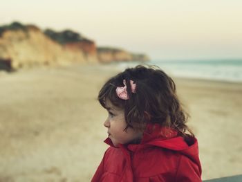 Close-up of girl looking away at beach