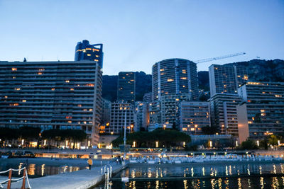 Illuminated buildings in city at dusk