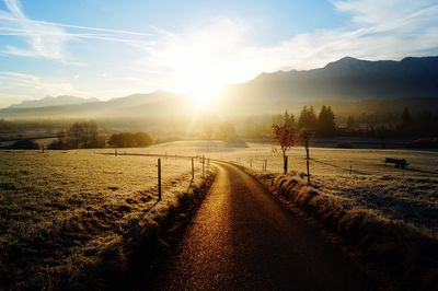 Narrow road along countryside landscape