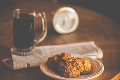 Cup of coffee, cookies and clock on table, still life 